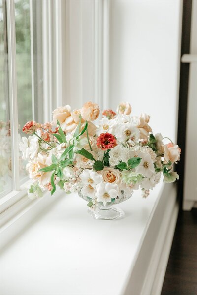 red, white, and peach floral arrangement for wedding
