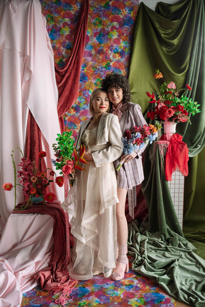 intimate wedding couple with east olivia flowers and draped velvet ceremony backdrop with floral flat vernacular wallpaper