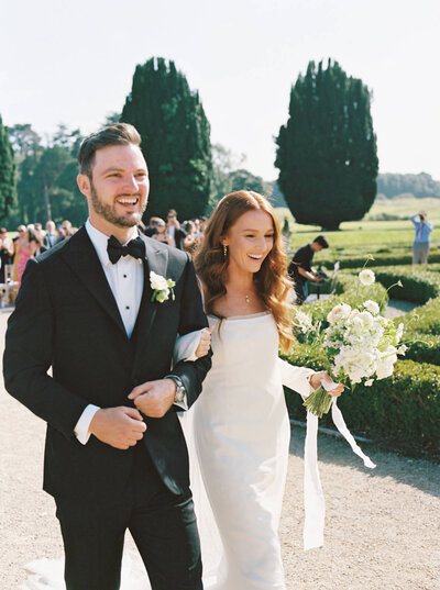 A groom leading his bride up the stairs in Chateau Du Grand Luce