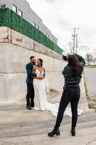 couple hug as photographer takes photo