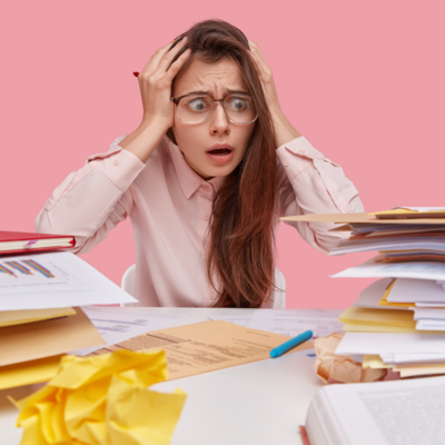 unorganized woman surrounded by paperwork