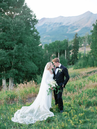 Couple at mountain sunset by Aspen Wedding Photographers