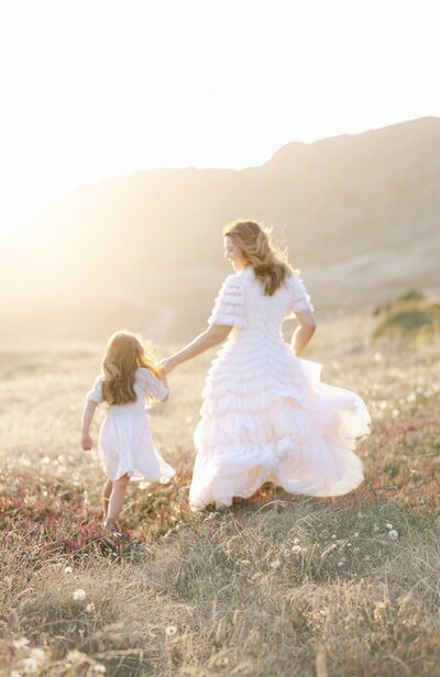 mom and daughter holding hands in golden hour taken by bay areamaternity photographer serving the bay area