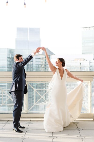 A wedded couple dance at their Atlanta Rooftop Wedding Venue.