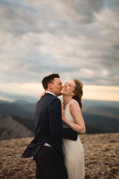 laughter filled image of bride and groom captured by calgary wedding photographer
