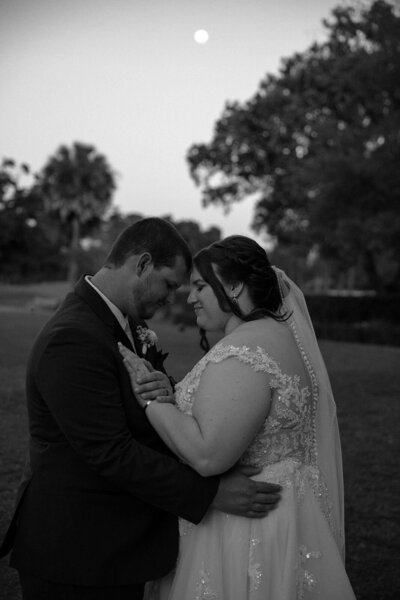 grooms kisses bride at the end of the aisle