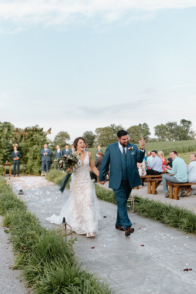 bride and groom walking down the aisle taken by wedding photographers in lexington