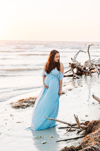 St. Pete mother to be looking stunning in a blue dress on st. pete beach