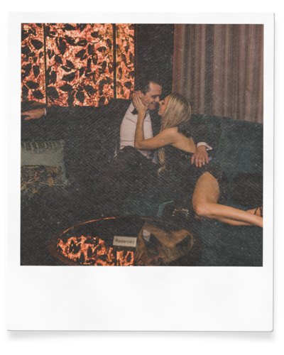 couple embraces in lounge during engagement session in las vegas