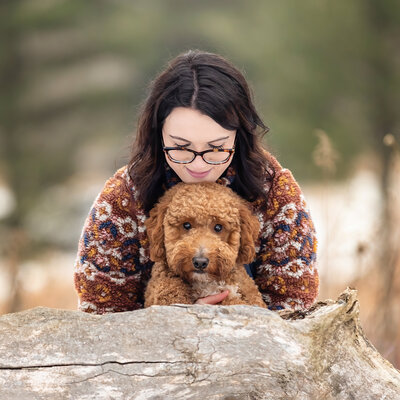 wall art of a woman hugging her black lab