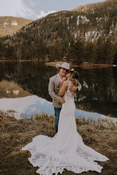 groom holding bride near colorado lake for colorado elopement photographer