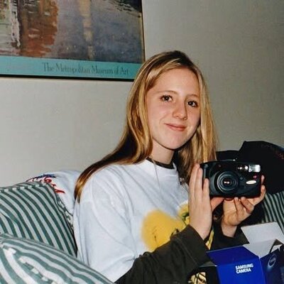 High school photo of Kristin Palkoner on birthday in 1995 holding a Samsung camera.