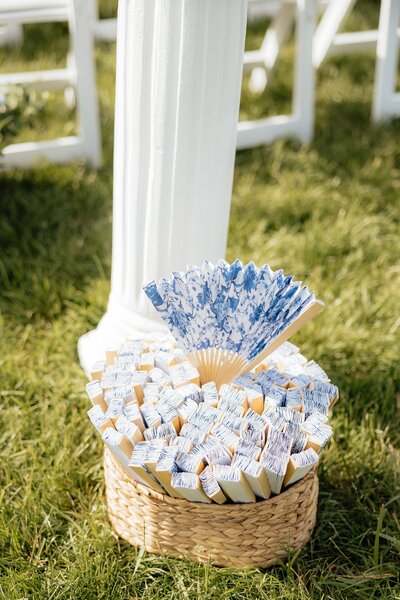 A basket of fans at a wedding ceremony.
