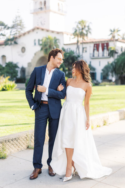 Summer elopement in Santa Barbara standing in front of the courthouse.