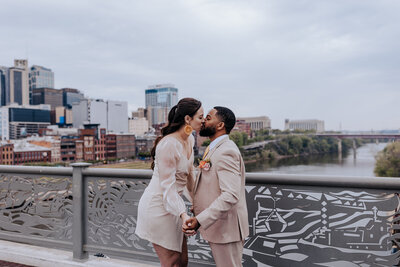 Nashville elopement photographer captures outdoor wedding photos of couple touching noses after their Nashville Elopement in Centennial Park