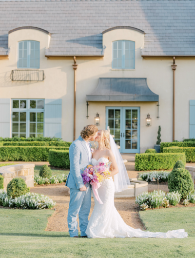 Couple in front of an elegant Oklahoma estate venue with Southern garden-inspired wedding design
