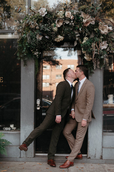 Emotional first look between Chris and Dave outside Quirk Hotel in downtown Richmond, captured in a candid, documentary style.