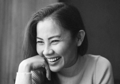 Close-up of a smiling woman, representing transformation through Angelica Ray’s spiritual guidance.