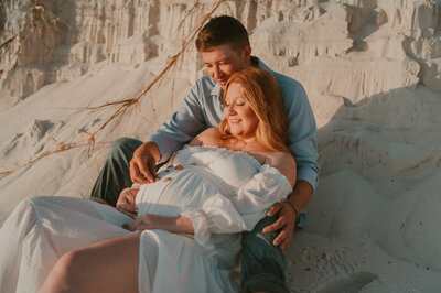 Maternity session on Pensacola Beach Florida looking at seashells. -Elopement-photographer-micro-wedding-destination-photographer-couples-picture