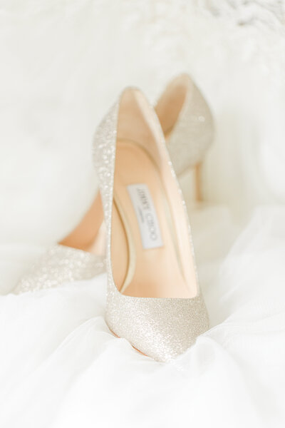 close up of wedding shoes jimmy choo silver glitter