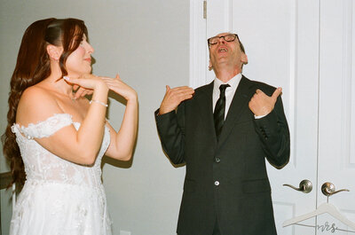 Bride and father of the bride caught on film waving their hands to their faces to try and stop tears for a first look with dad. Wedding in Washington D.C.