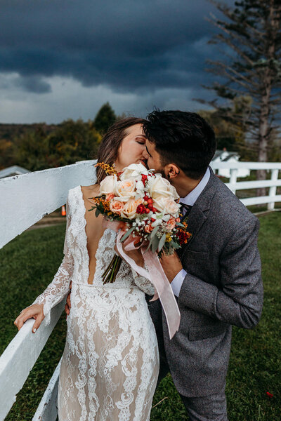 Bride and groom kiss at sunset