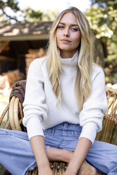 blonde woman in a white sweater | carlisledigitalmarketing.com