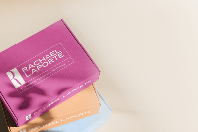 Two female business owners working on laptop and making notes