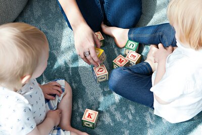 Parents Engaging with Baby in Playful Carpet Games