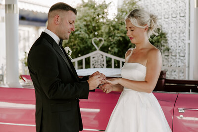 A couple during their wedding ceremony saying their vows and laughing 