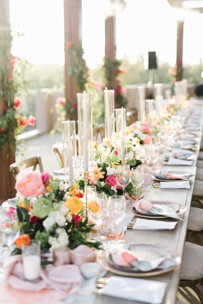 Wedding reception table with florals and elegant placesettings