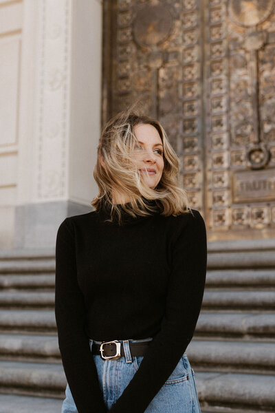 Woman looks into the business on the steps of an elegant building in Tennessee