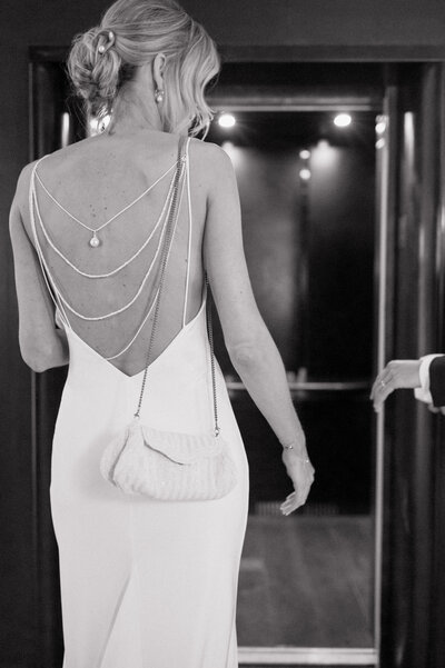 Bride and Groom walk into an elevator at The Surety Hotel. Photo by Anna Brace, who specializes in wedding photography in Des Moines Iowa.
