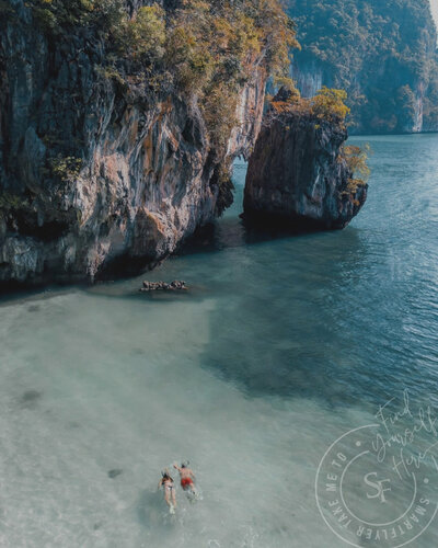 Divers explore the crystal-clear waters of the Phi Phi Islands in Thailand, surrounded by towering limestone cliffs and vibrant marine life, evoking a cinematic adventure.