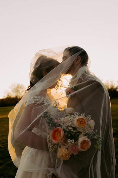 A groom giving his bride a kiss during their bridal portraits at the terrance in upstate south carolina 