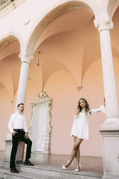 groom looking at bride leaning on a column by south florida wedding photographers