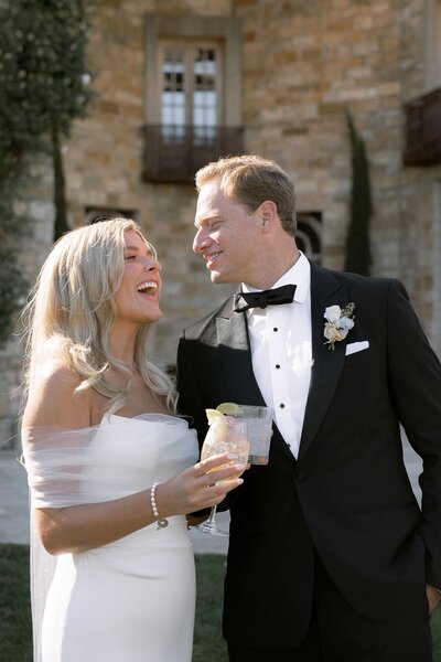 Groom covers his eyes as he sees his beautiful bride on their wedding day at San Juan Capistrano Mission