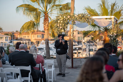 A photographer taking pictures at a wedding.