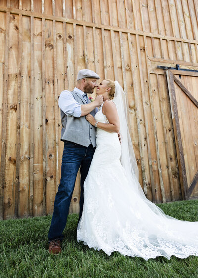 Photo of a bride and groom looking at each other in front of a barn in Erie Pa