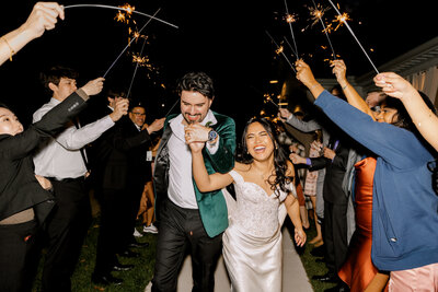 bride and groom leaving their wedding day with a sparkler send off in Michigan