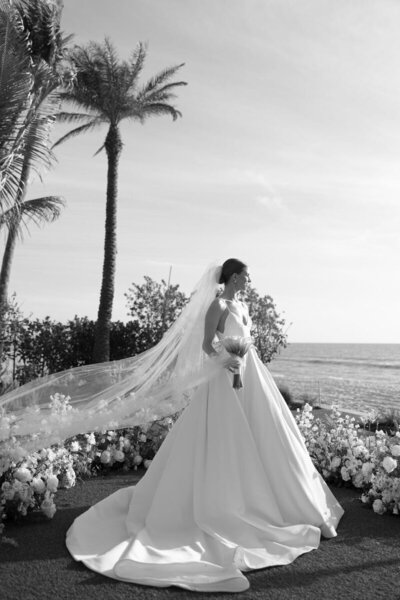 bride looking onto the ocean, taken by wedding photographer fort myers