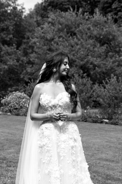 Vermont Wedding Photographer | Sincerely Liz Photography Documentary Wedding, Engagement, Elopement, Maternity and Newborn Photographer in New England | Bride looking over to her right posing at an outdoor wedding venue in black and white