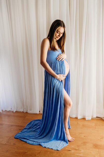 pregnant mom in a walnut creek open space wearing blue maternity gown