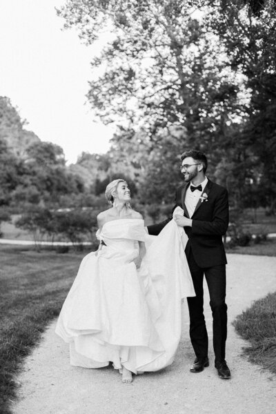 Bride and groom kiss and clink champagne glasses at Castle and Key Distillery in Lexington Kentucky photographed by Lexington Kentucky luxury film wedding photographer Magnolia Tree Photo Company