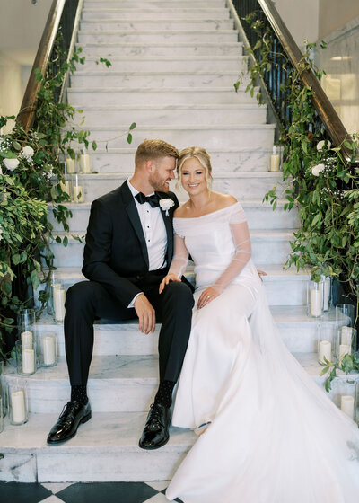 a bride and groom holding hands while sharing a private moment