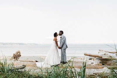 a couple kissing on a beach during their Washington elopement