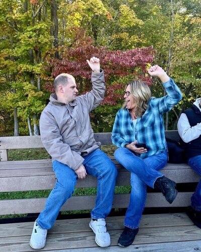 Image of solid rock friend high-fiving on bench.