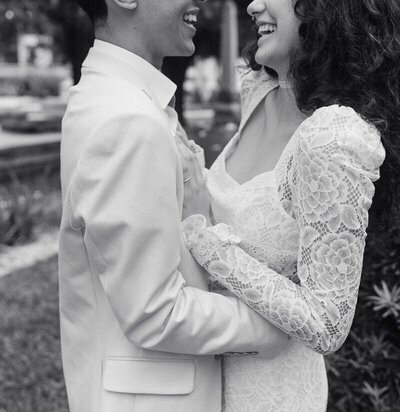 bride and groom laughing at each other on wedding day by east coast photographer