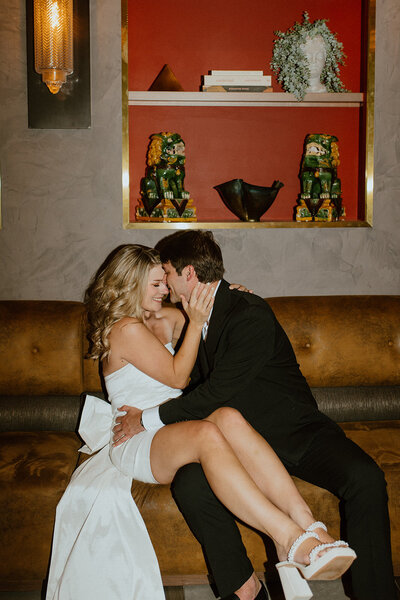 man kisses wife on couch modern atlanta engagement
