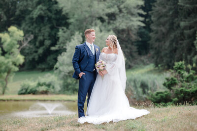 Bride and groom portrait in front of a pond at Bryn Awel Manor.